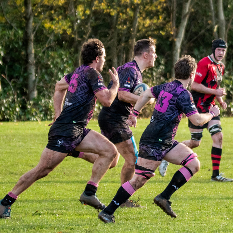 Bisons RFC players running with the ball